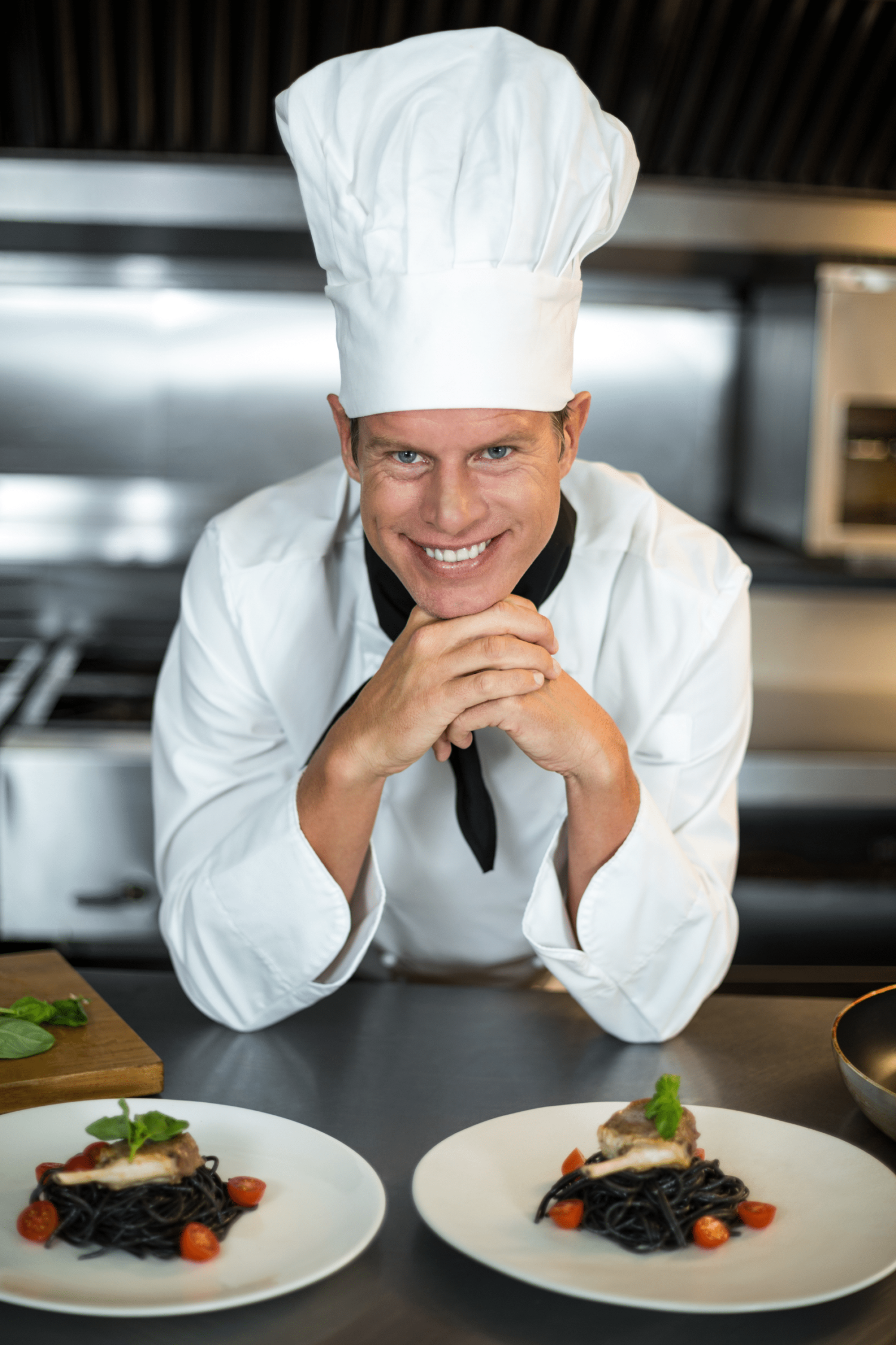 Chef in kitchen with chefs hat