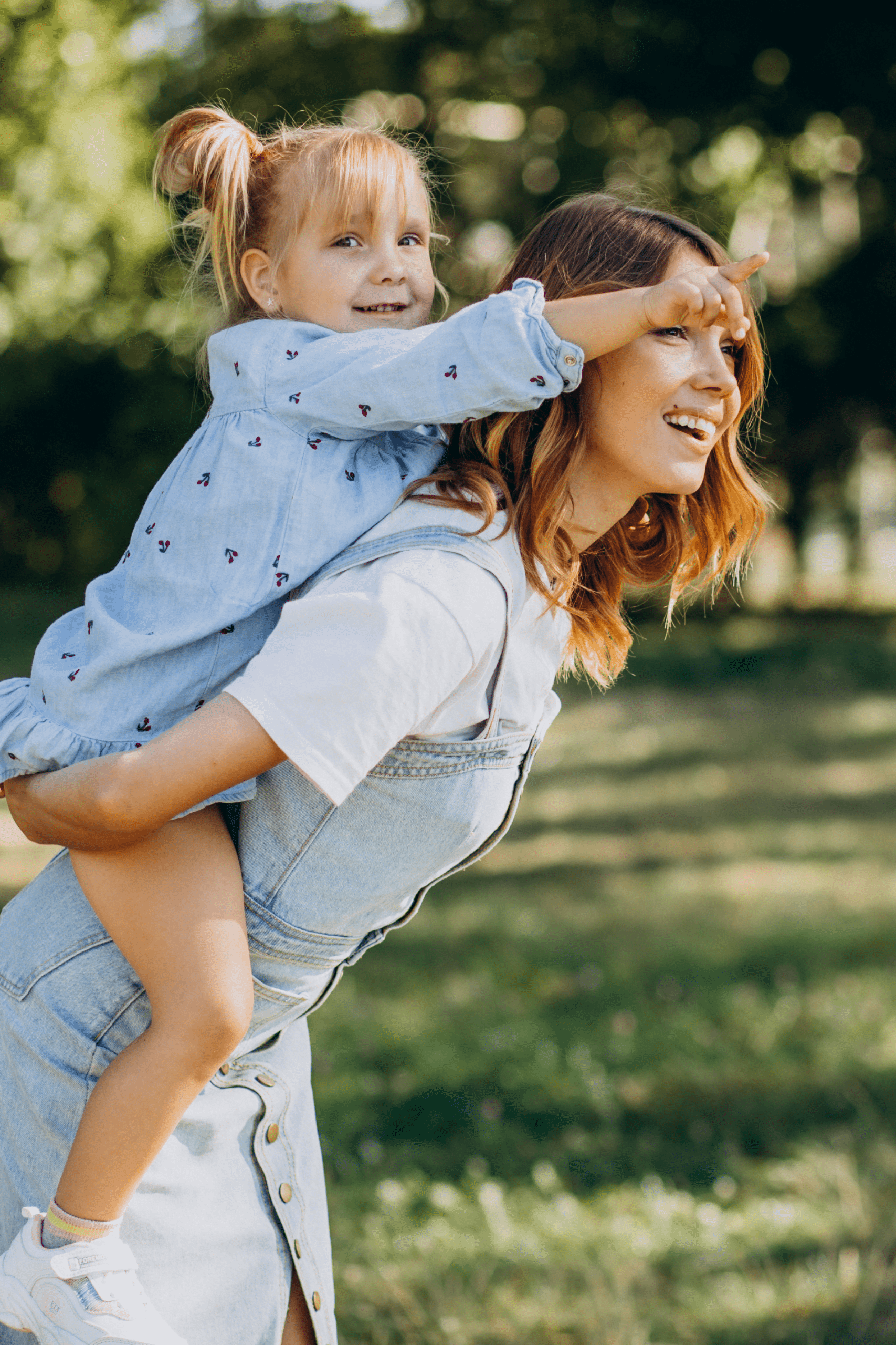 Mother giving daughter a piggy back ride