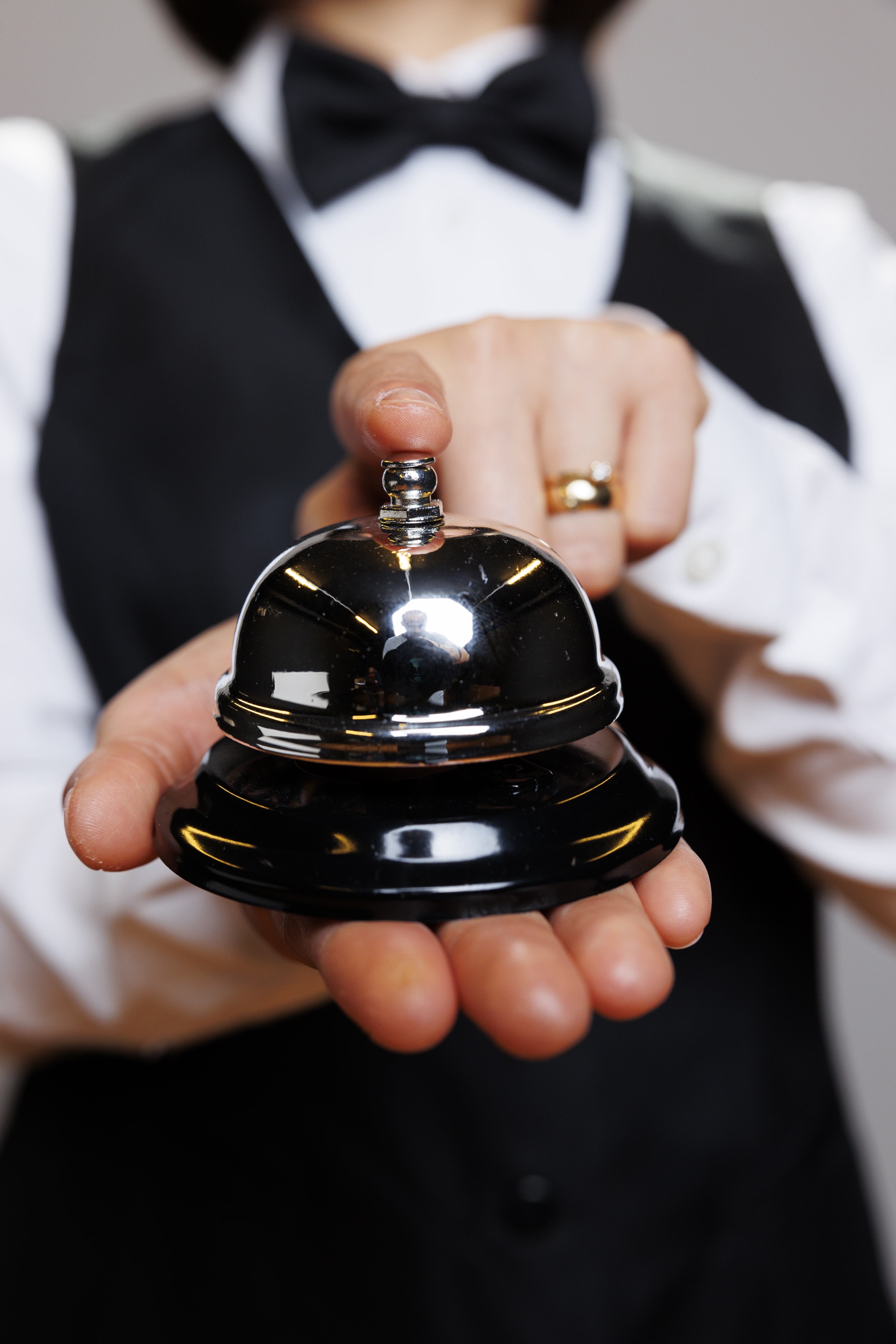 Waitress ringing bell with finger